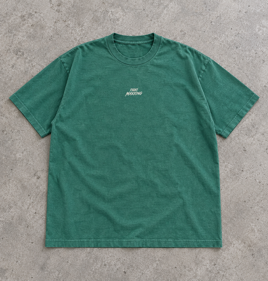 Fight Maxxing relaxed tee in green, laid flat on grey cement
