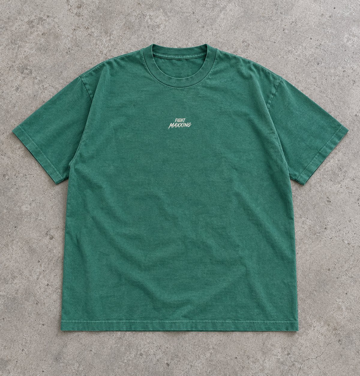 Fight Maxxing relaxed tee in green, laid flat on grey cement