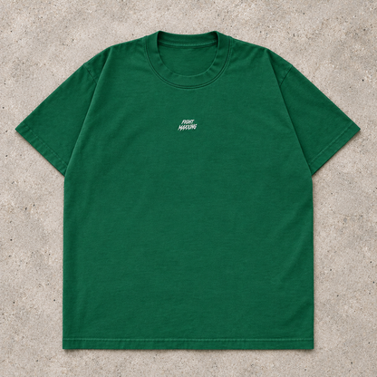 Fight Maxxing relaxed tee in green, laid flat on grey cement
