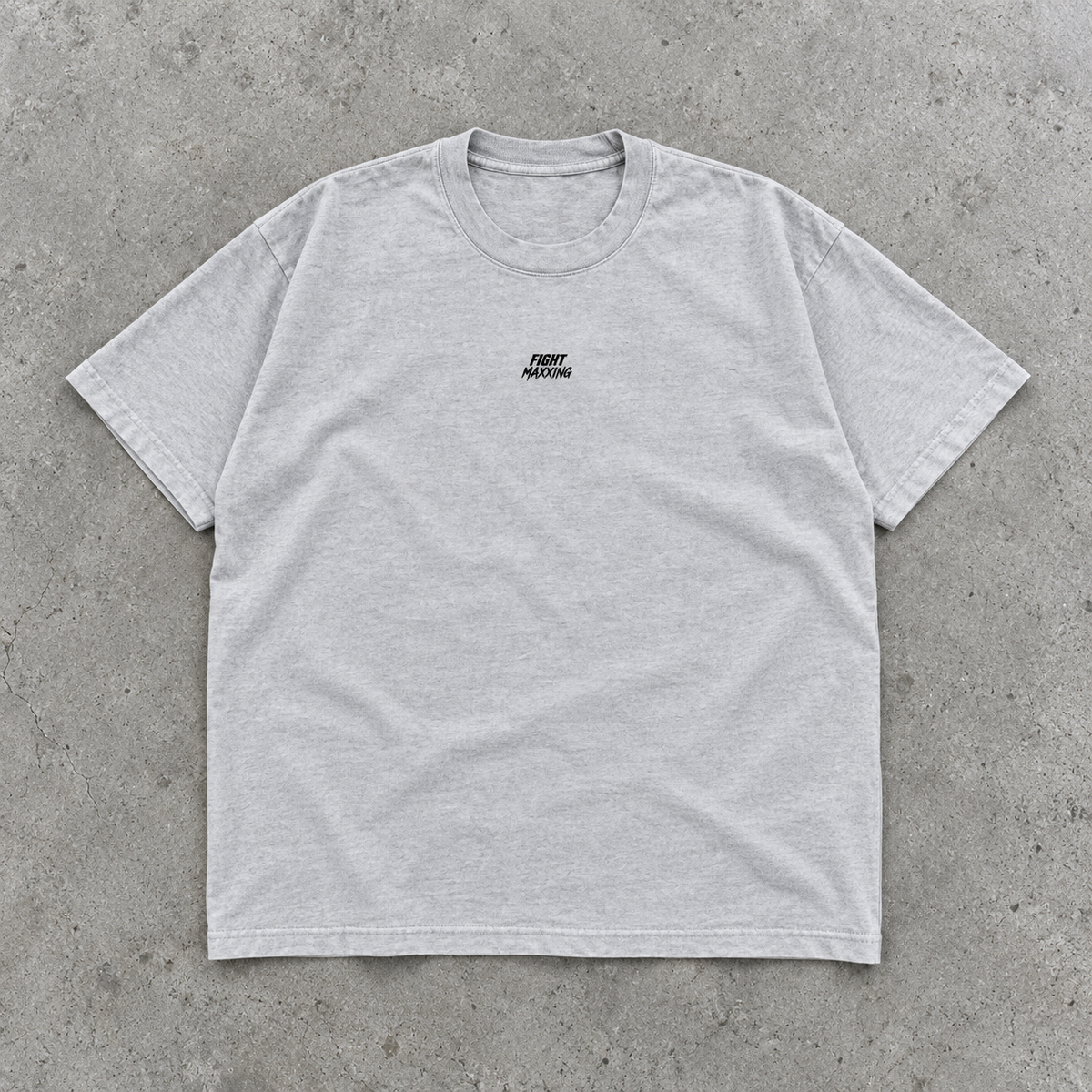 Fight Maxxing relaxed tee in grey, laid flat on grey cement